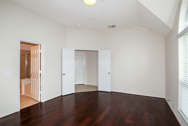 unfurnished bedroom featuring wood-type flooring and lofted ceiling