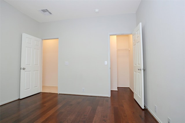 unfurnished bedroom with dark hardwood / wood-style floors