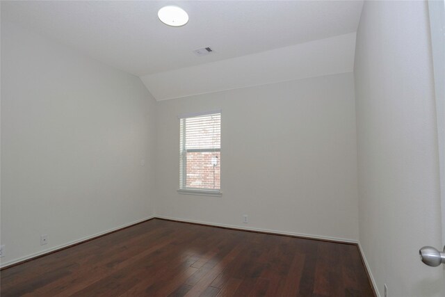 unfurnished room featuring lofted ceiling and dark hardwood / wood-style floors