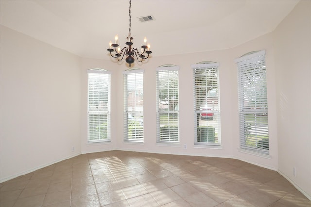 unfurnished dining area with light tile patterned floors and a notable chandelier