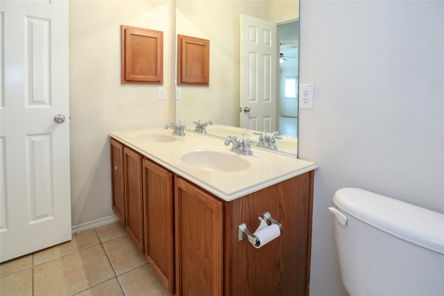 bathroom featuring vanity, tile patterned floors, and toilet