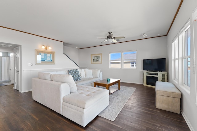 living room with ornamental molding, dark hardwood / wood-style floors, and ceiling fan