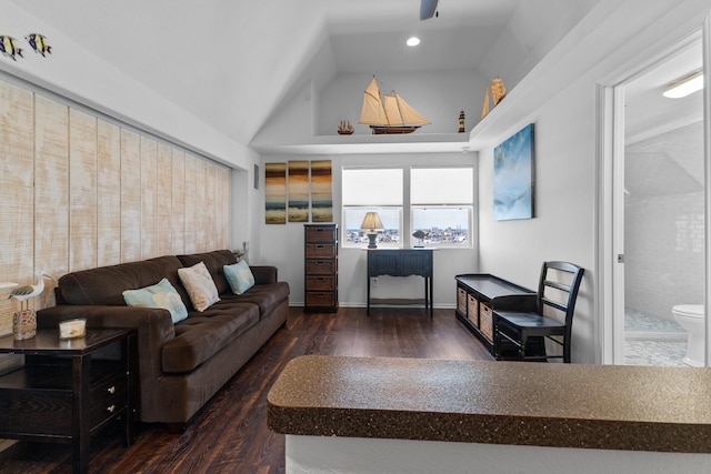 living room with dark hardwood / wood-style flooring and vaulted ceiling