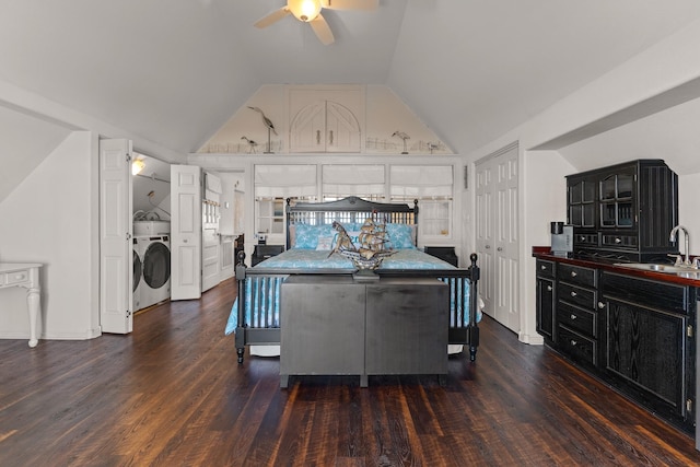 bedroom with sink, dark wood-type flooring, washer / clothes dryer, and vaulted ceiling