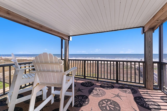 wooden terrace with a water view and a beach view