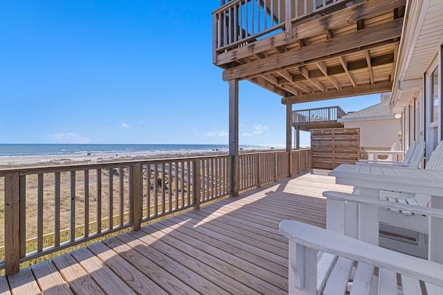 deck with a view of the beach and a water view