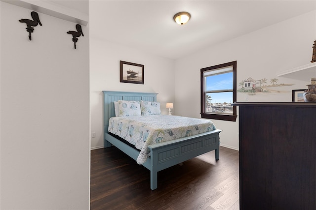 bedroom with dark wood-type flooring