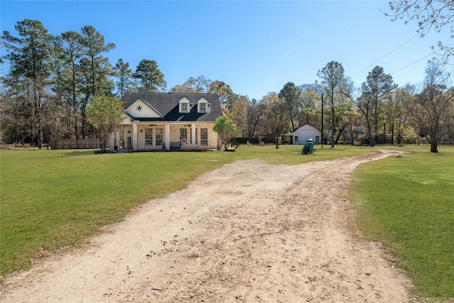 cape cod-style house featuring a front yard