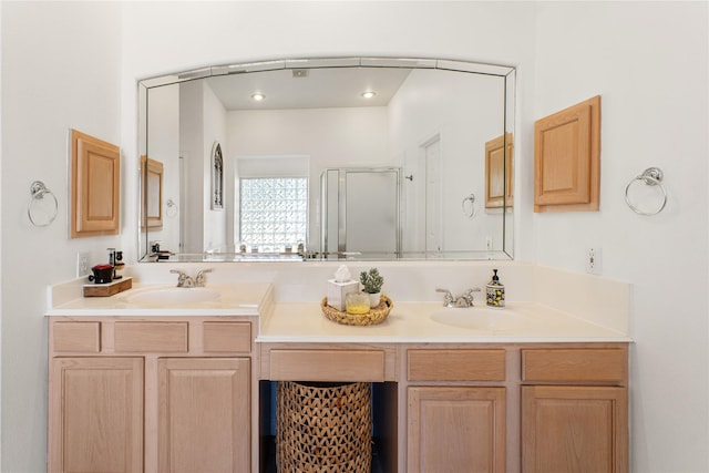 bathroom featuring vanity and a shower with shower door