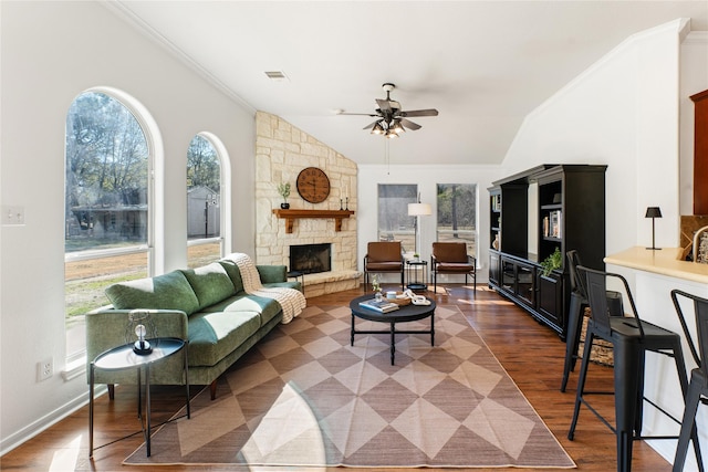 living room featuring vaulted ceiling, a fireplace, dark hardwood / wood-style flooring, ornamental molding, and ceiling fan