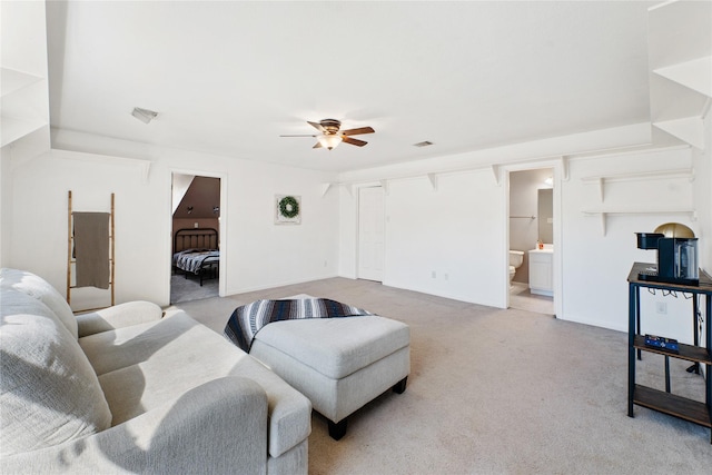 carpeted living room with ceiling fan