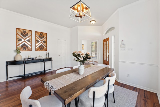 dining room with dark hardwood / wood-style flooring, ornamental molding, and a chandelier