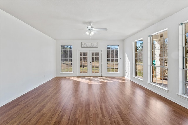 unfurnished sunroom featuring french doors and ceiling fan