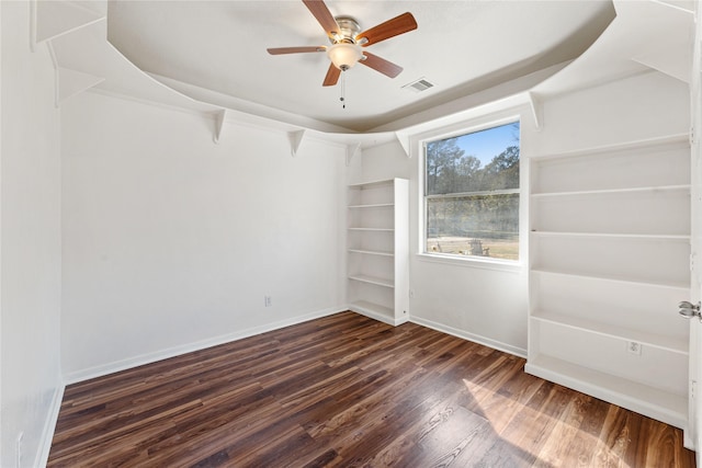 empty room featuring dark hardwood / wood-style flooring and ceiling fan