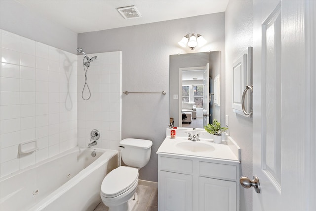 full bathroom with vanity, tiled shower / bath combo, and toilet