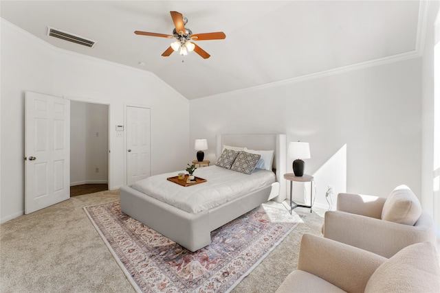 carpeted bedroom with vaulted ceiling, ornamental molding, and ceiling fan