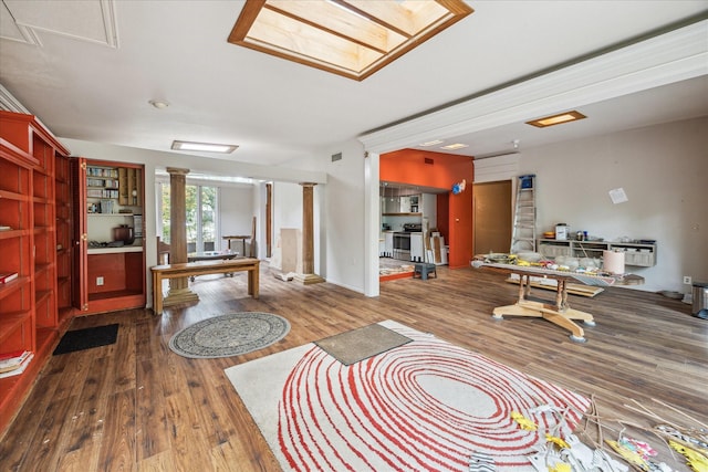 living room with hardwood / wood-style flooring and ornate columns