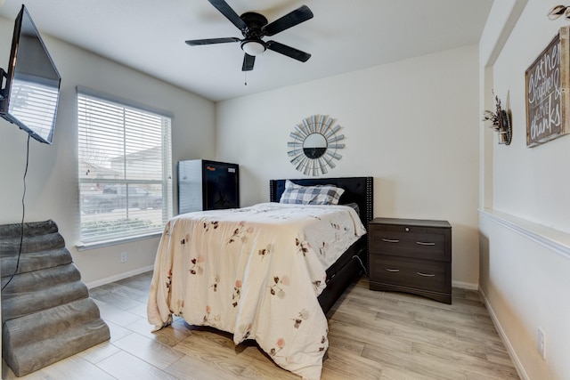 bedroom with ceiling fan and light hardwood / wood-style floors