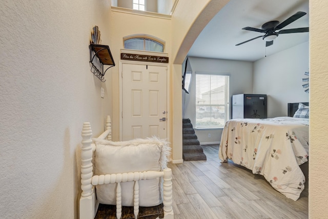 bedroom with ceiling fan and light wood-type flooring