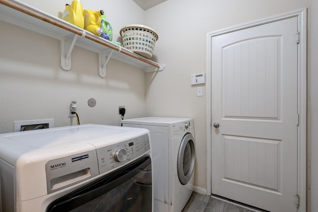 washroom featuring dark hardwood / wood-style flooring and washer and dryer