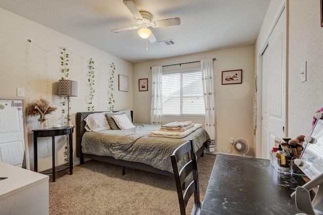 bedroom featuring ceiling fan, light colored carpet, and a closet