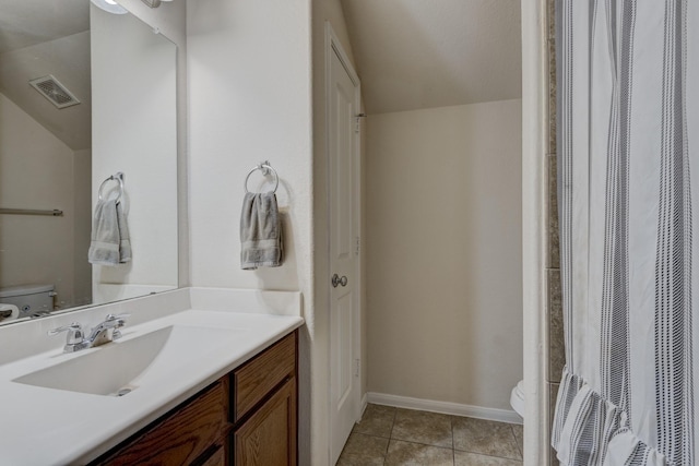 bathroom featuring tile patterned floors, toilet, and vanity