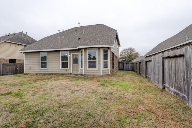 back of property featuring a yard