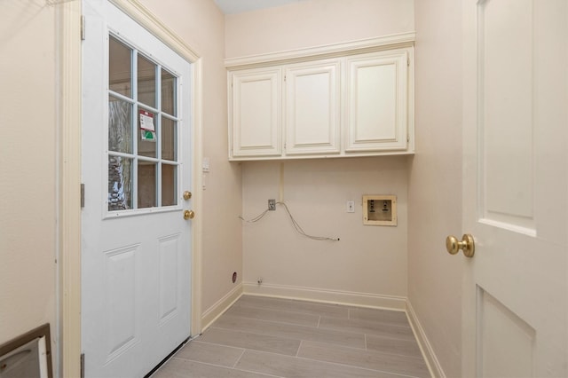 clothes washing area with cabinets and hookup for a washing machine