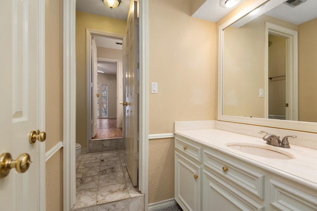 bathroom with vanity and toilet