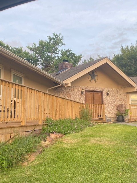 exterior space featuring a lawn and a deck