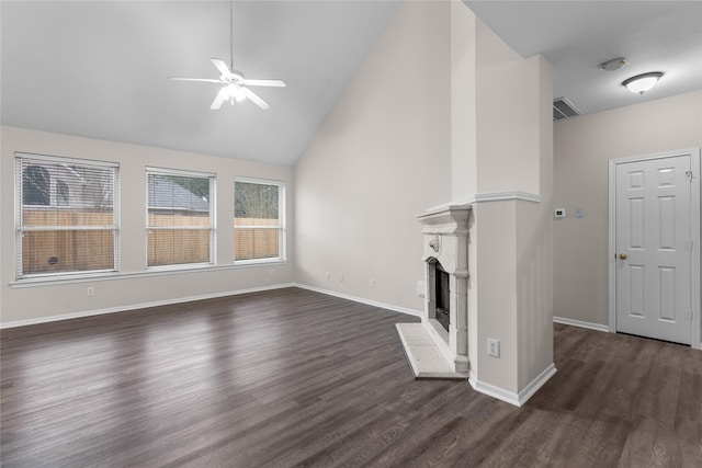 unfurnished living room with ceiling fan, dark hardwood / wood-style floors, and high vaulted ceiling