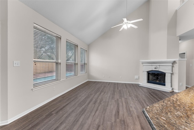 unfurnished living room with ceiling fan, dark hardwood / wood-style flooring, and high vaulted ceiling