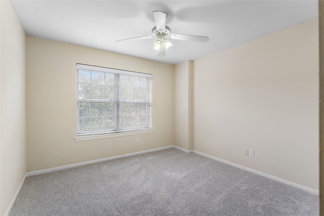 spare room with carpet floors and ceiling fan