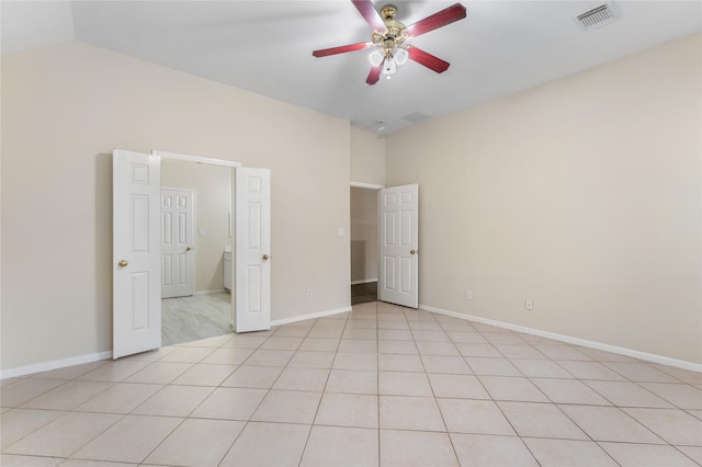 unfurnished bedroom with light tile patterned flooring, ceiling fan, and vaulted ceiling