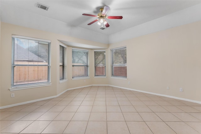 spare room with a wealth of natural light and ceiling fan