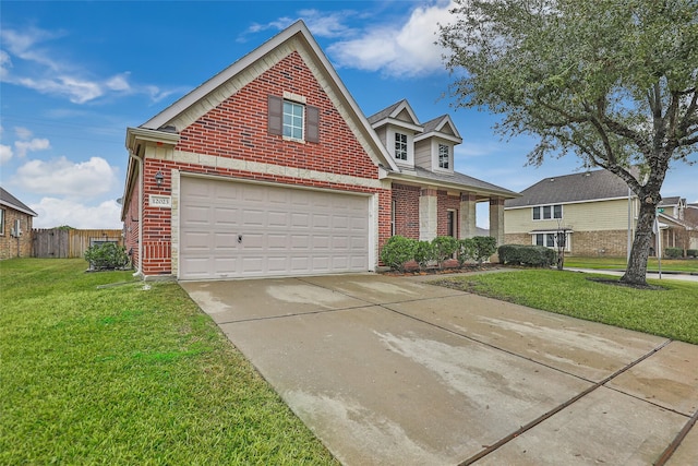 traditional-style house featuring driveway, fence, a front lawn, and brick siding