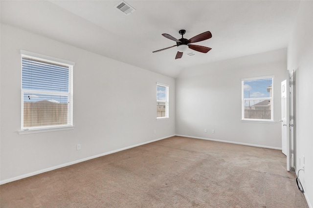 unfurnished room featuring carpet, visible vents, ceiling fan, and baseboards