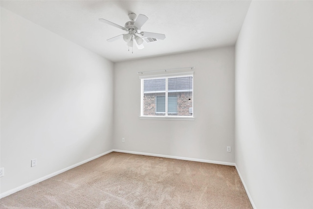 spare room with carpet flooring, a ceiling fan, and baseboards