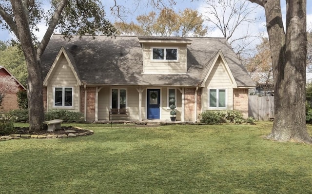 view of front of home with a front yard and covered porch