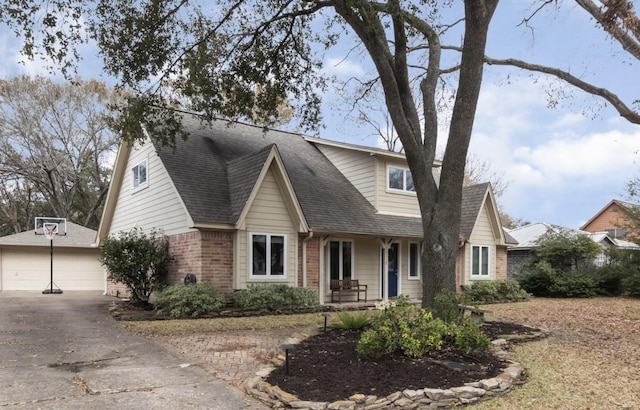 view of front of house with a garage, an outdoor structure, and covered porch