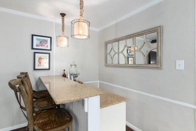 bar featuring ornamental molding and pendant lighting