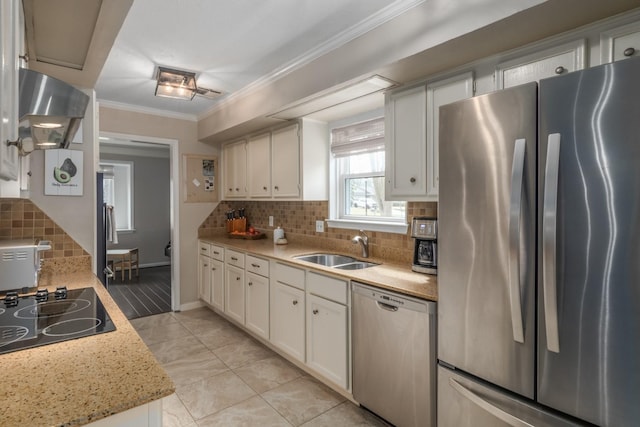 kitchen featuring sink, ornamental molding, white cabinets, and appliances with stainless steel finishes