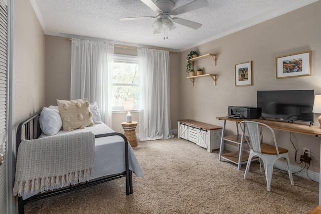 bedroom with ceiling fan, ornamental molding, carpet floors, and a textured ceiling