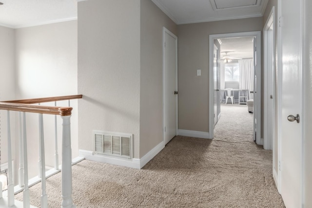 corridor featuring crown molding and light carpet