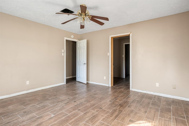 spare room featuring ceiling fan and a textured ceiling