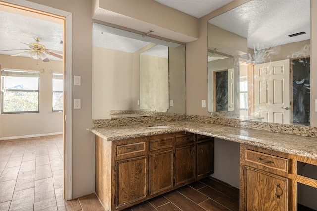 kitchen featuring ceiling fan and a textured ceiling