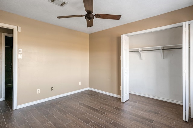 unfurnished bedroom with a closet, dark hardwood / wood-style floors, and ceiling fan