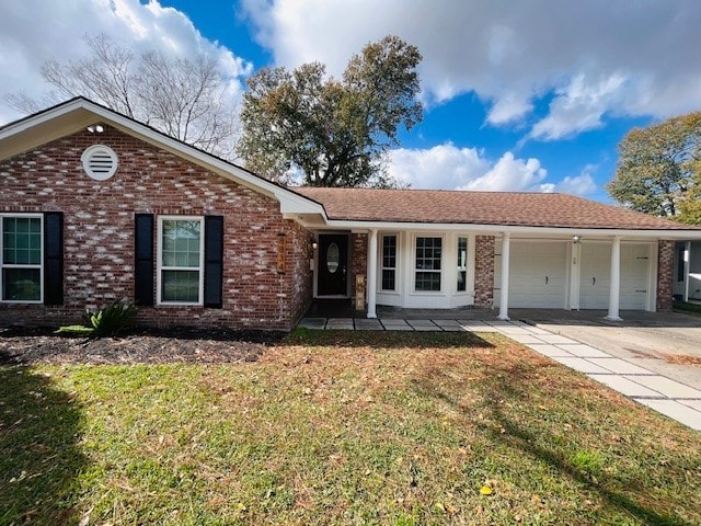 ranch-style house featuring a garage and a front lawn