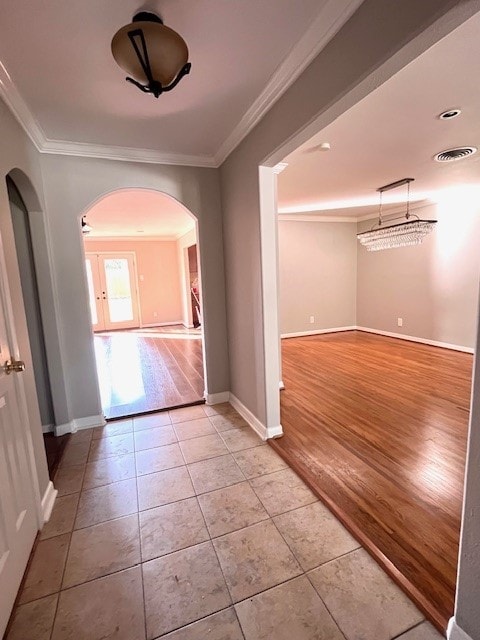 tiled spare room with ornamental molding