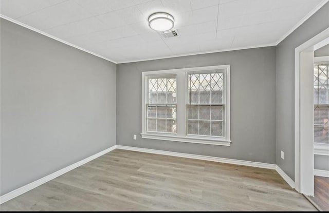 unfurnished room featuring light hardwood / wood-style flooring and ornamental molding